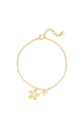 Subtiele armband met bloem en strik bedel goud